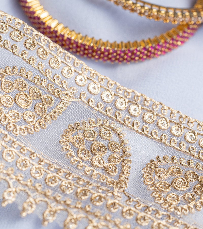 Gold with zari threadwork in paisley pattern on tissue base