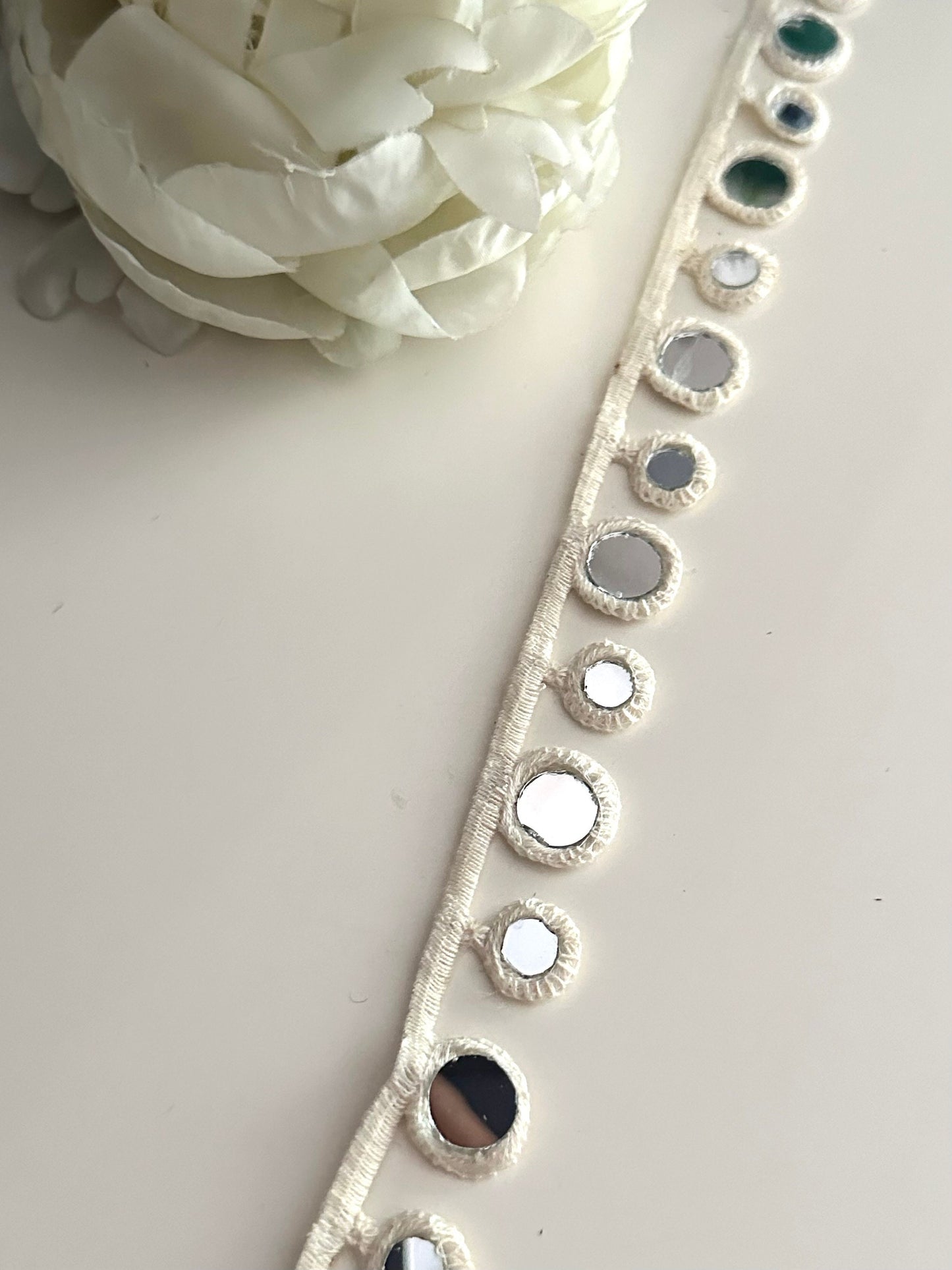 2cm cotton lace with geometric design and reflective mirrors.