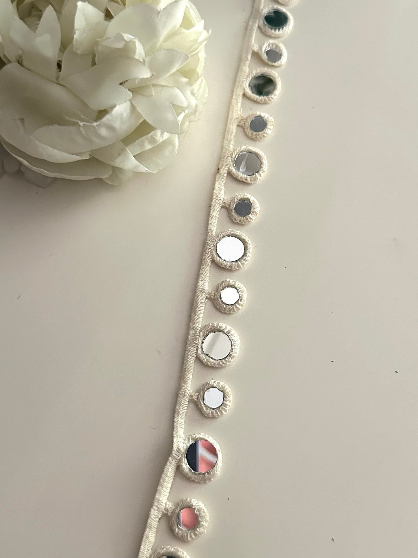 Geometric mirror lace trim used on a handmade accessory.