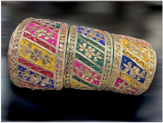 Embroidered lace trim Gota Patti lace with colorful floral design and gold accents
Vibrant Indian lace border with intricate details
Handmade boho lace trim with unique pattern and colors