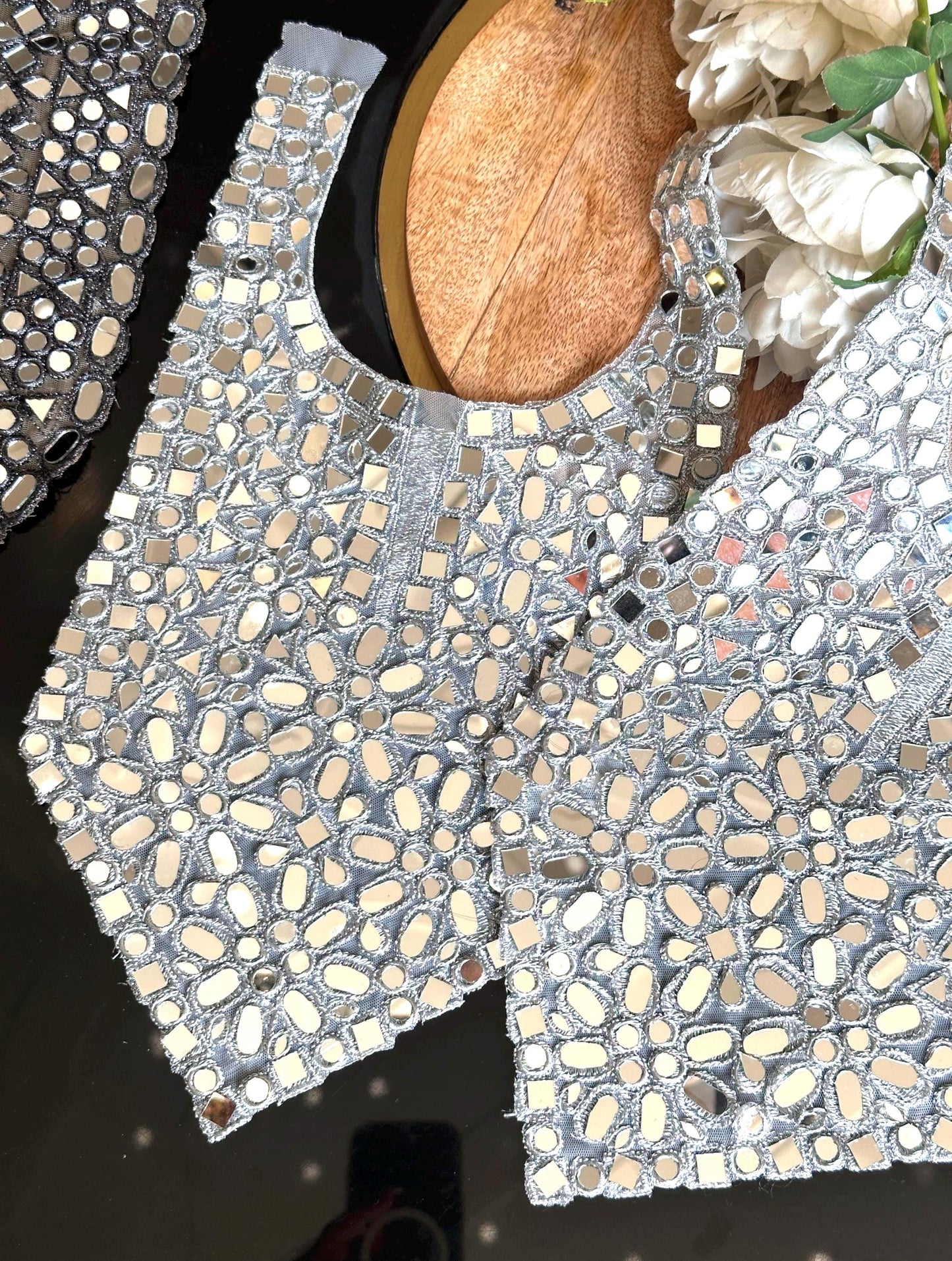 Close-up of boho chic neck patch with mirror work for wedding dresses