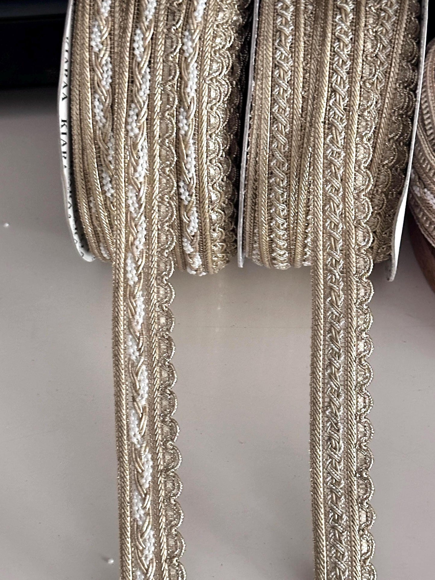 Two styles of luxury gold fabric trims for sewing and costume design.