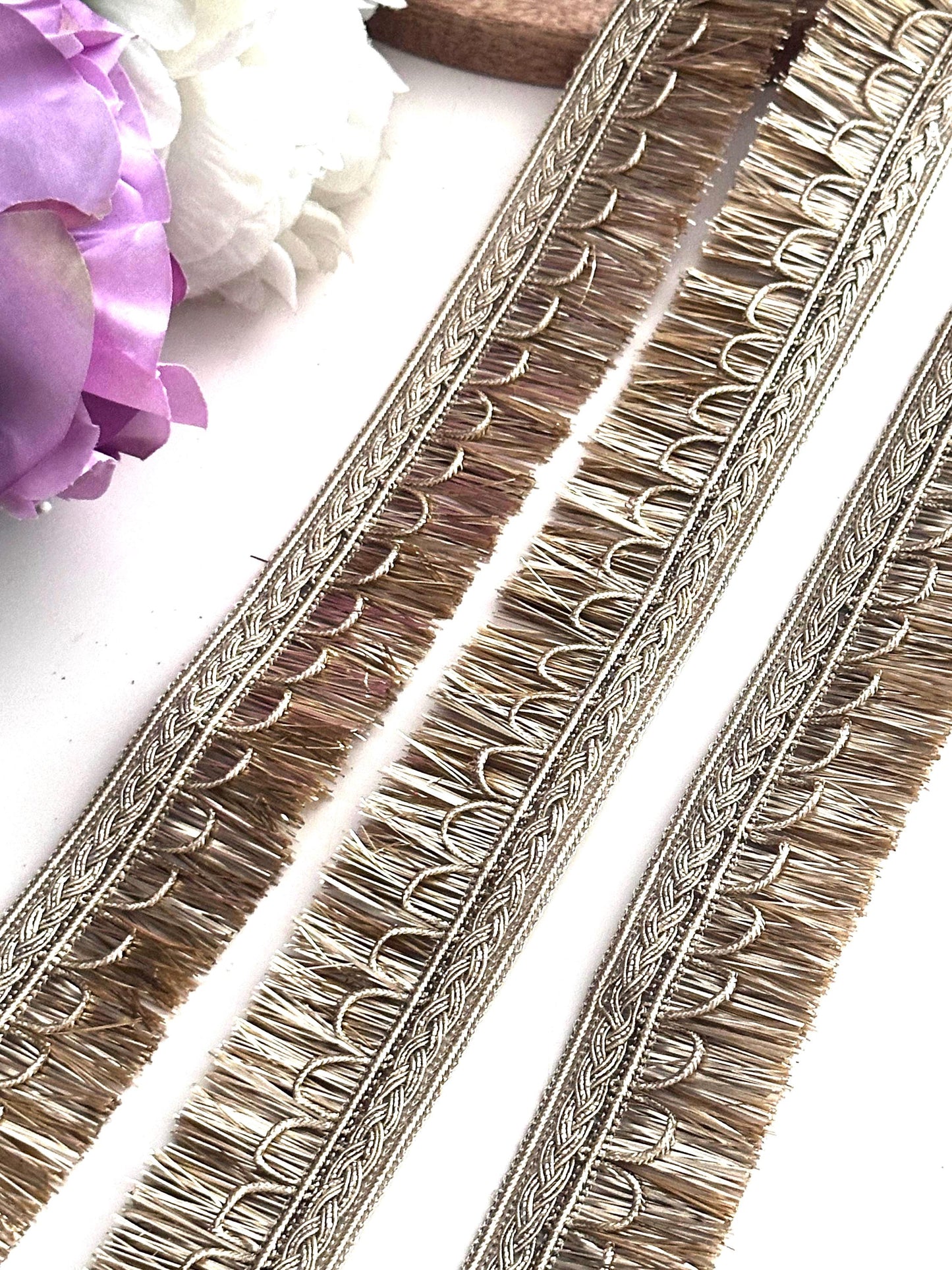 Decorative gold ribbon with embroidery details, perfect for creative sewing projects.
Rolls of gold lace ribbon used for crafting, wedding décor, and fashion accessories.
Elegant gold embroidered trim displayed on a spool for fabric embellishment and DIY crafts.