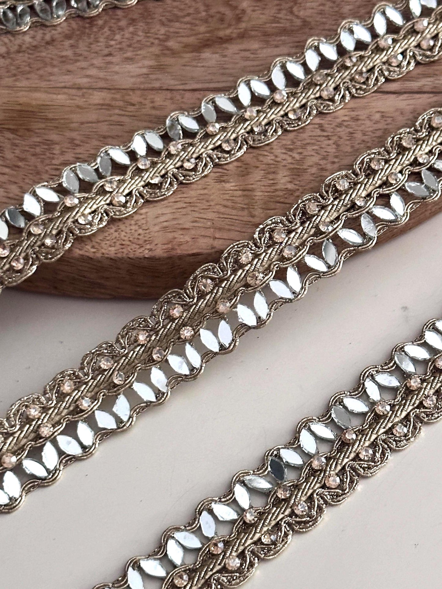 Golden mirror ribbon trim roll with sparkling accents, perfect for bridal gown detailing, lehenga embellishments, or saree edging."