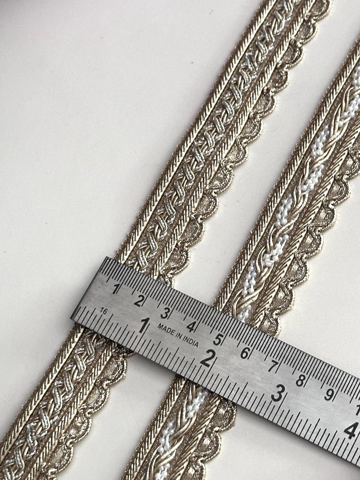 Two styles of luxury gold fabric trims for sewing and costume design.