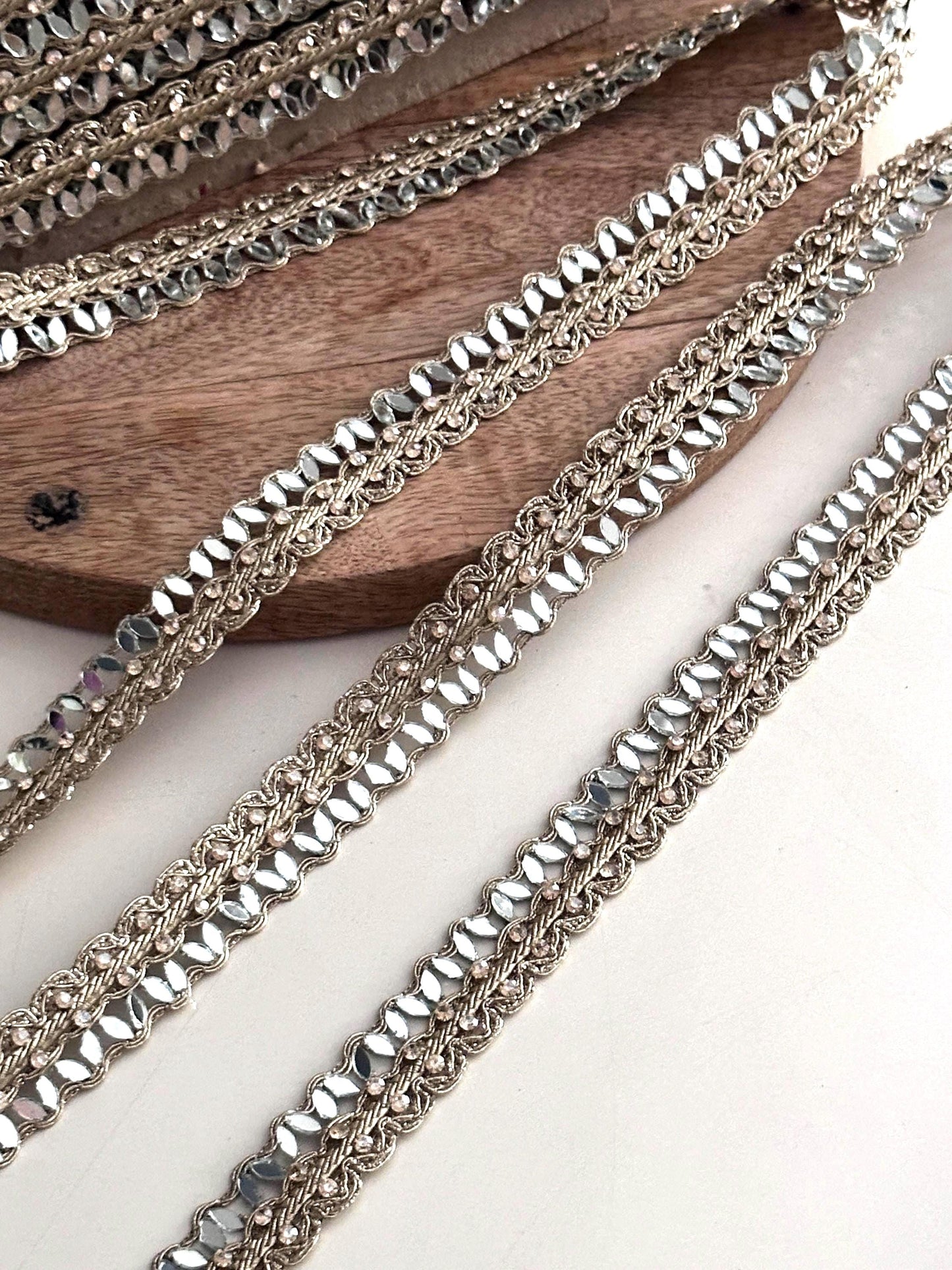 Golden crystal trim used as an elegant saree border, enhancing traditional Indian attire with a glamorous touch.