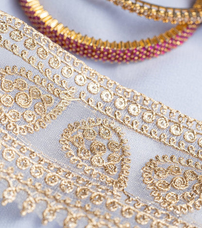 Gold with zari threadwork in paisley pattern on tissue base