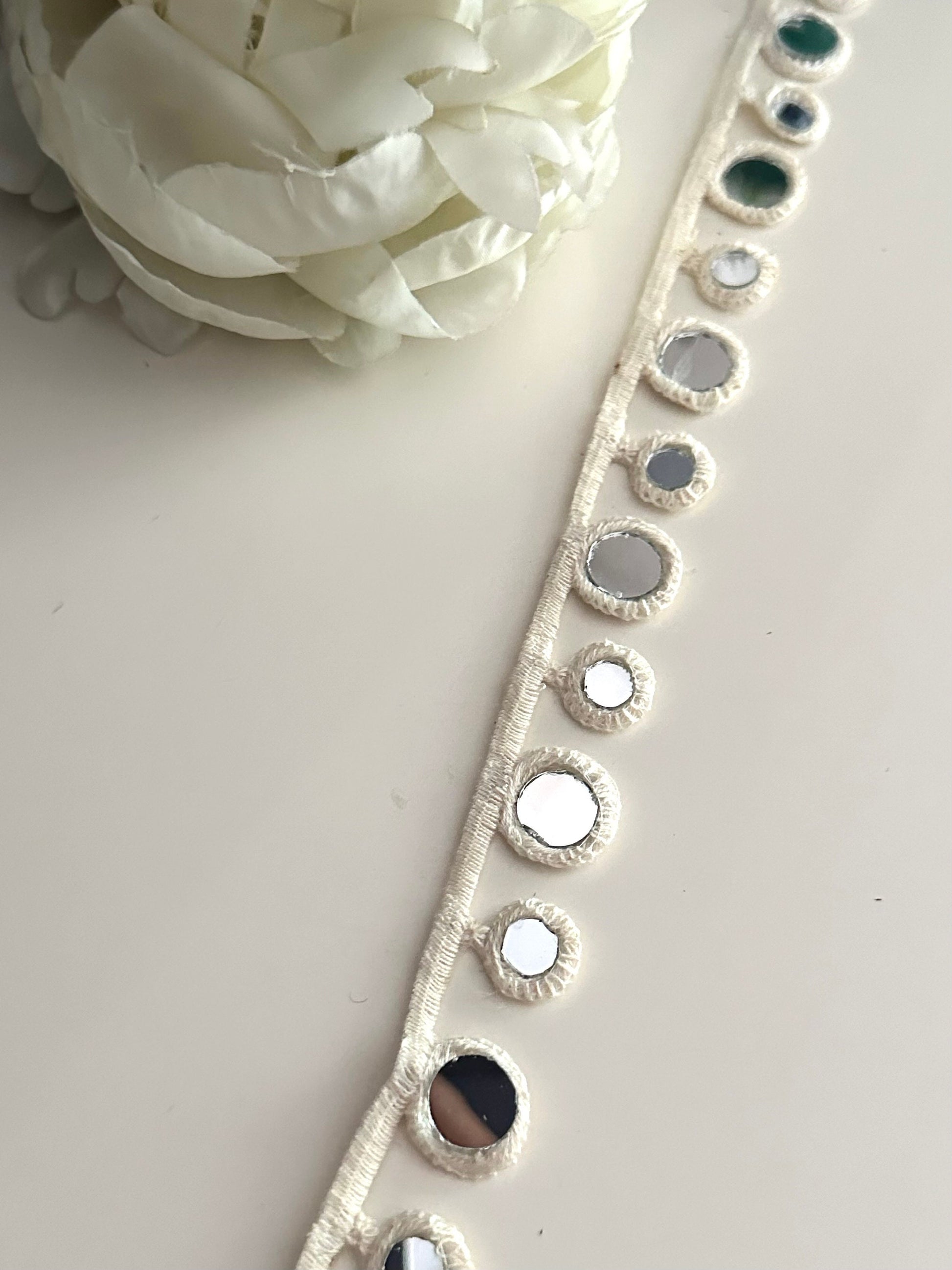 2cm cotton lace with geometric design and reflective mirrors.