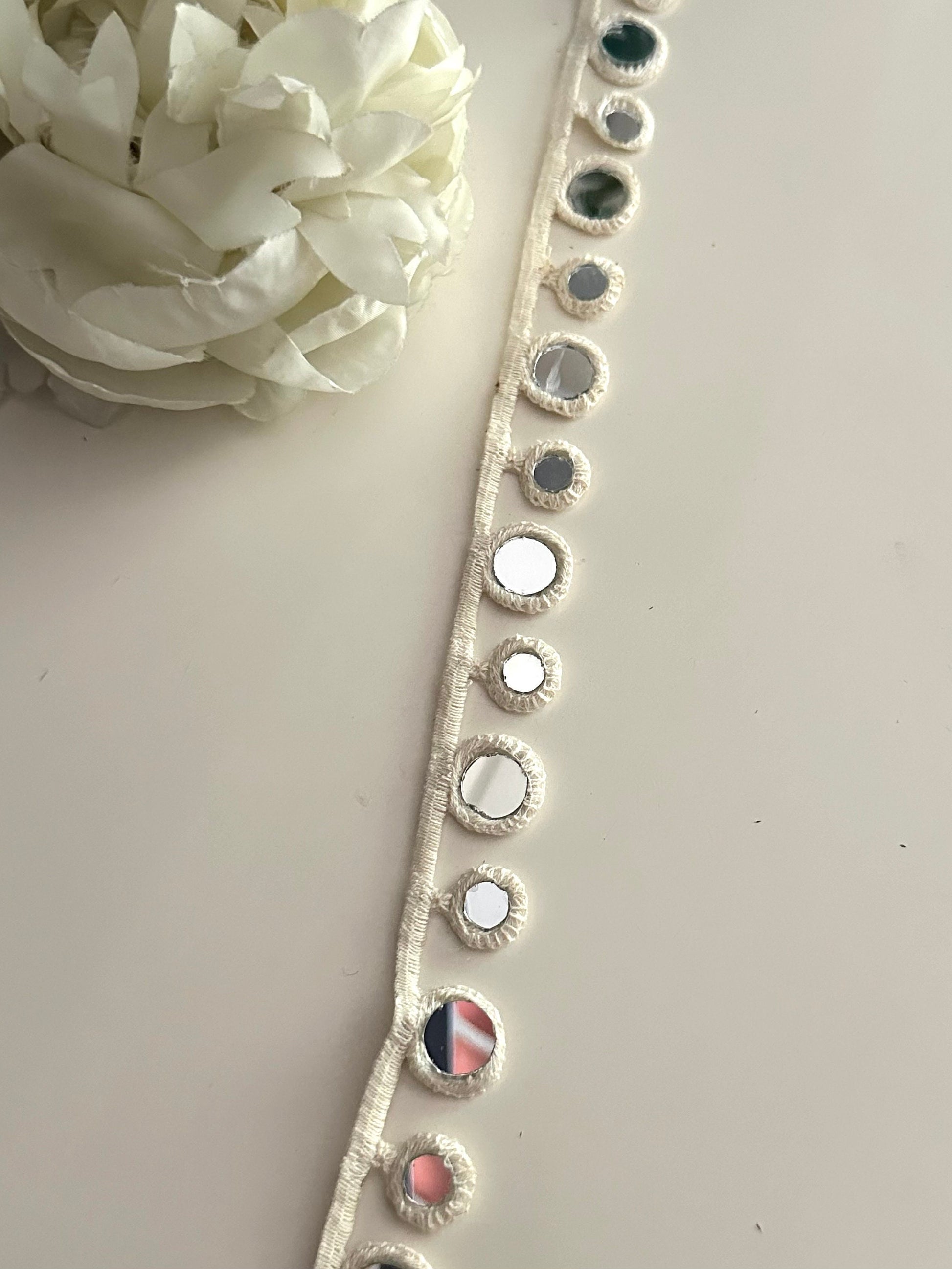 Geometric mirror lace trim used on a handmade accessory.
