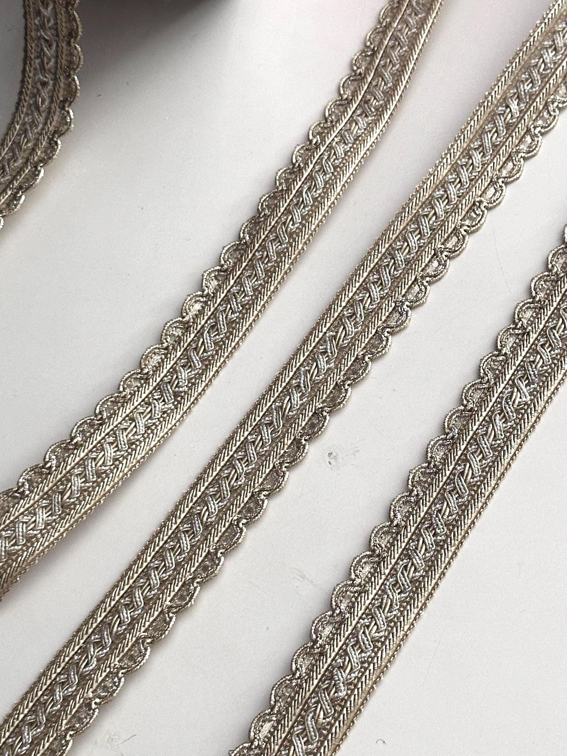 Two styles of luxury gold fabric trims for sewing and costume design.