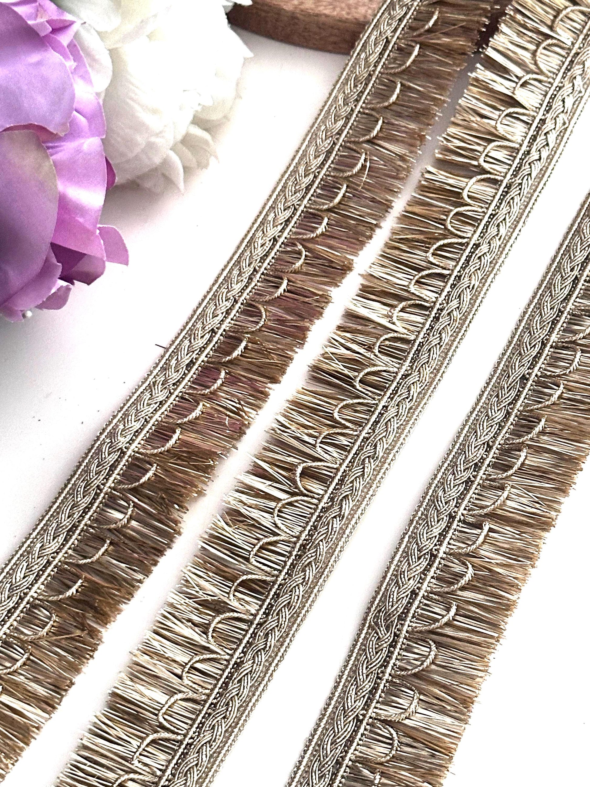 Decorative gold ribbon with embroidery details, perfect for creative sewing projects.
Rolls of gold lace ribbon used for crafting, wedding décor, and fashion accessories.
Elegant gold embroidered trim displayed on a spool for fabric embellishment and DIY crafts.