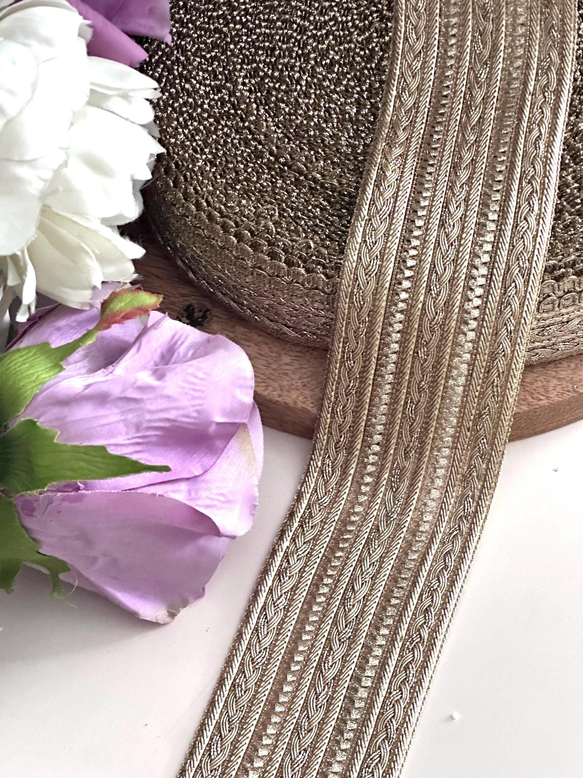 Elegant gold decorative trim with a textured finish for costumes and crafts.