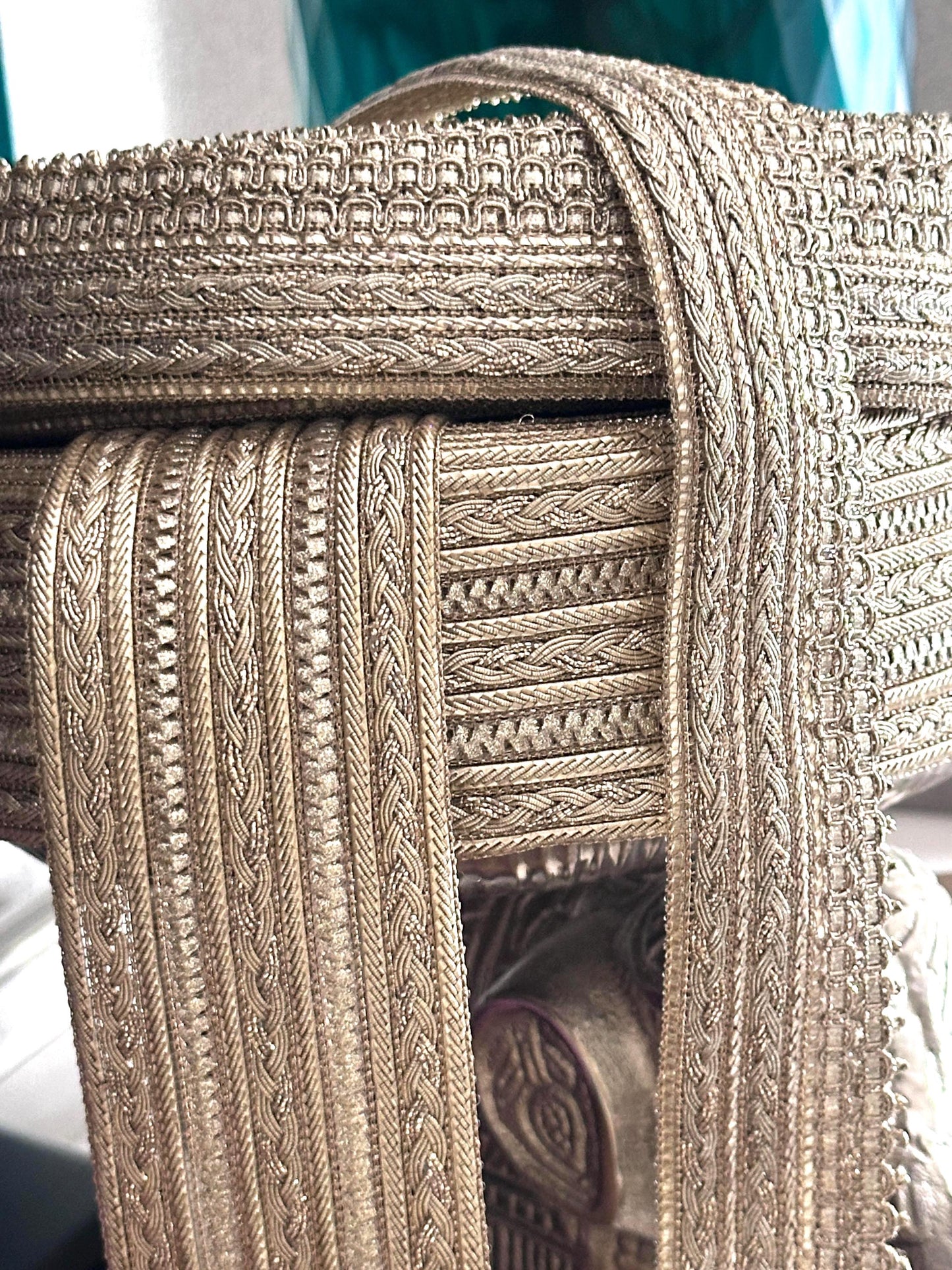 Elegant gold decorative trim with a textured finish for costumes and crafts.
Rolls of gold embroidered lace ribbon, perfect for sewing and embellishments.
Shimmering gold metallic trim displayed on fabric rolls for crafting and design