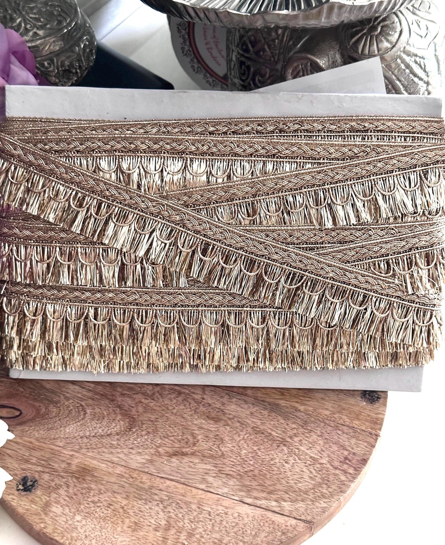 Close-up of metallic thread lace trim for ethnic wear, bridal gowns, and costume design.