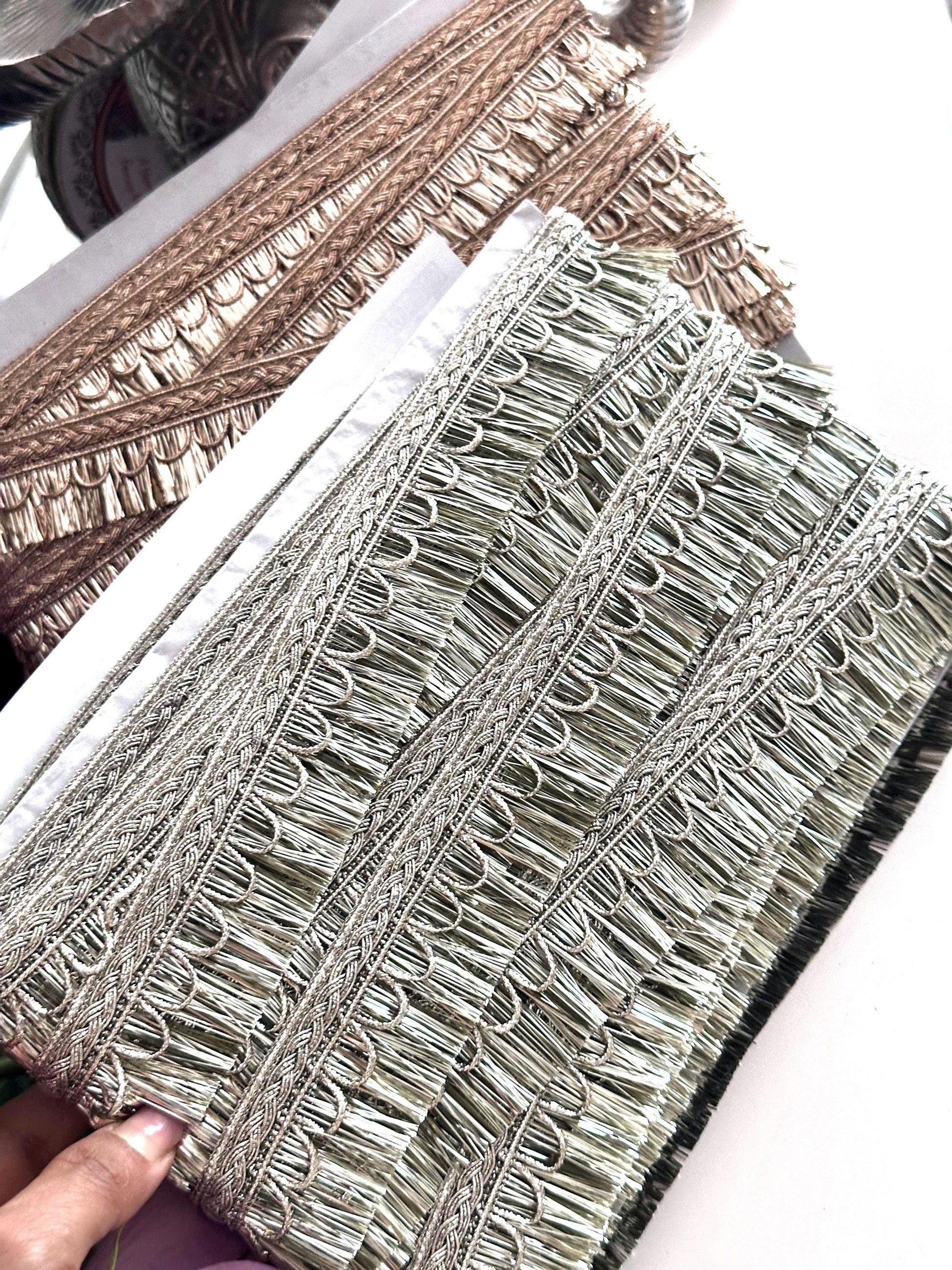 Decorative gold ribbon with embroidery details, perfect for creative sewing projects.