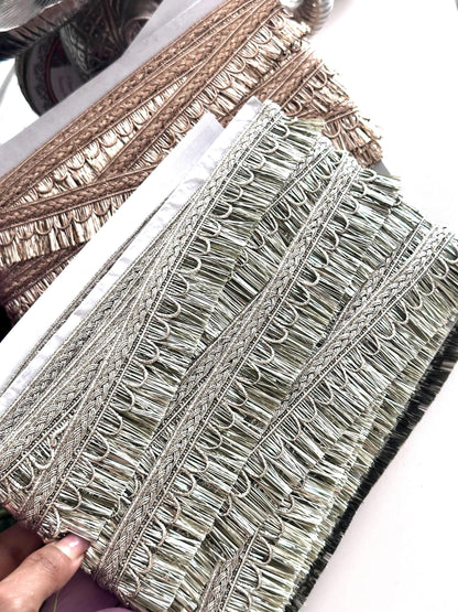 Decorative gold ribbon with embroidery details, perfect for creative sewing projects.