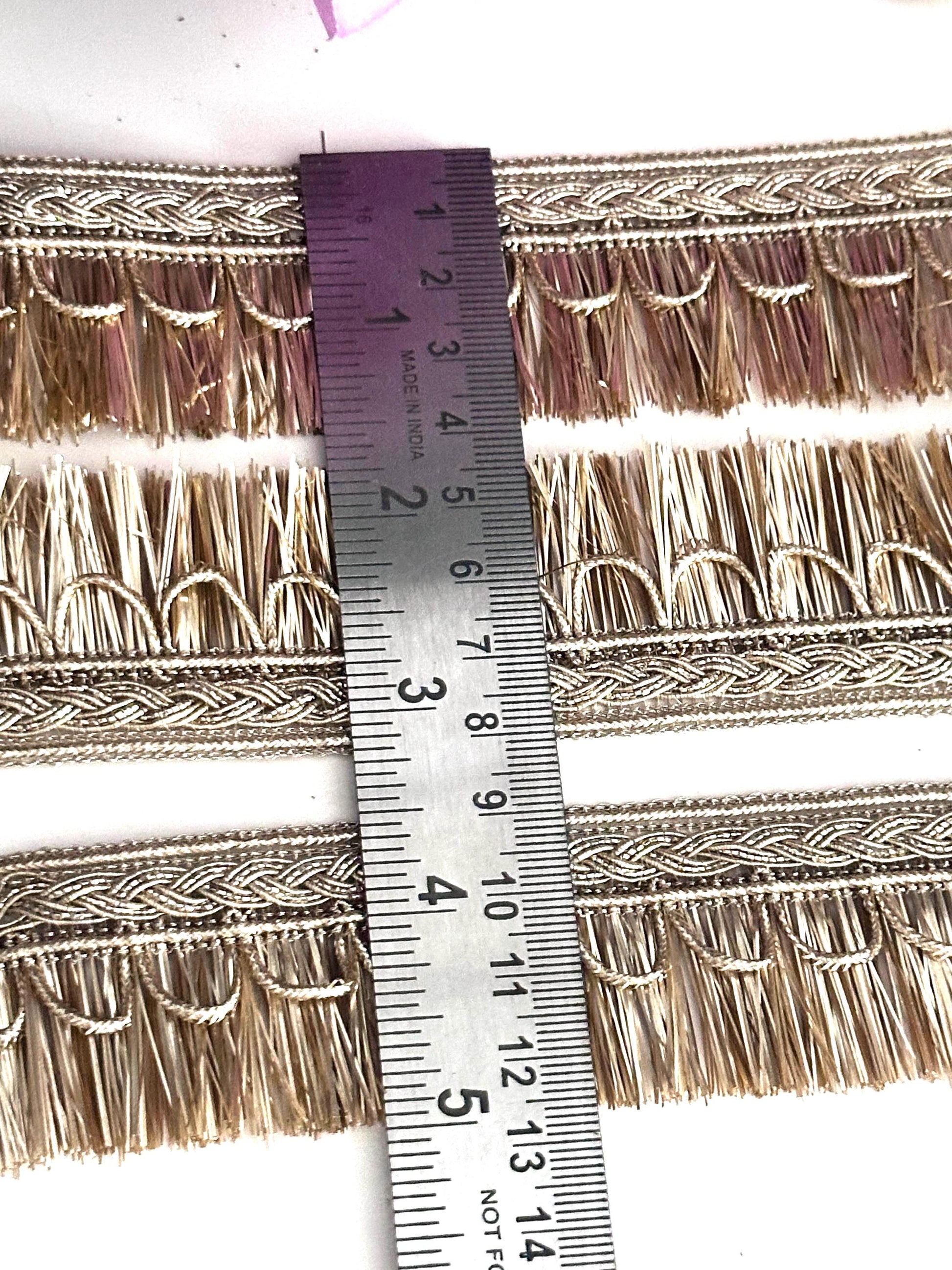 Rolls of gold lace ribbon used for crafting, wedding décor, and fashion accessories.