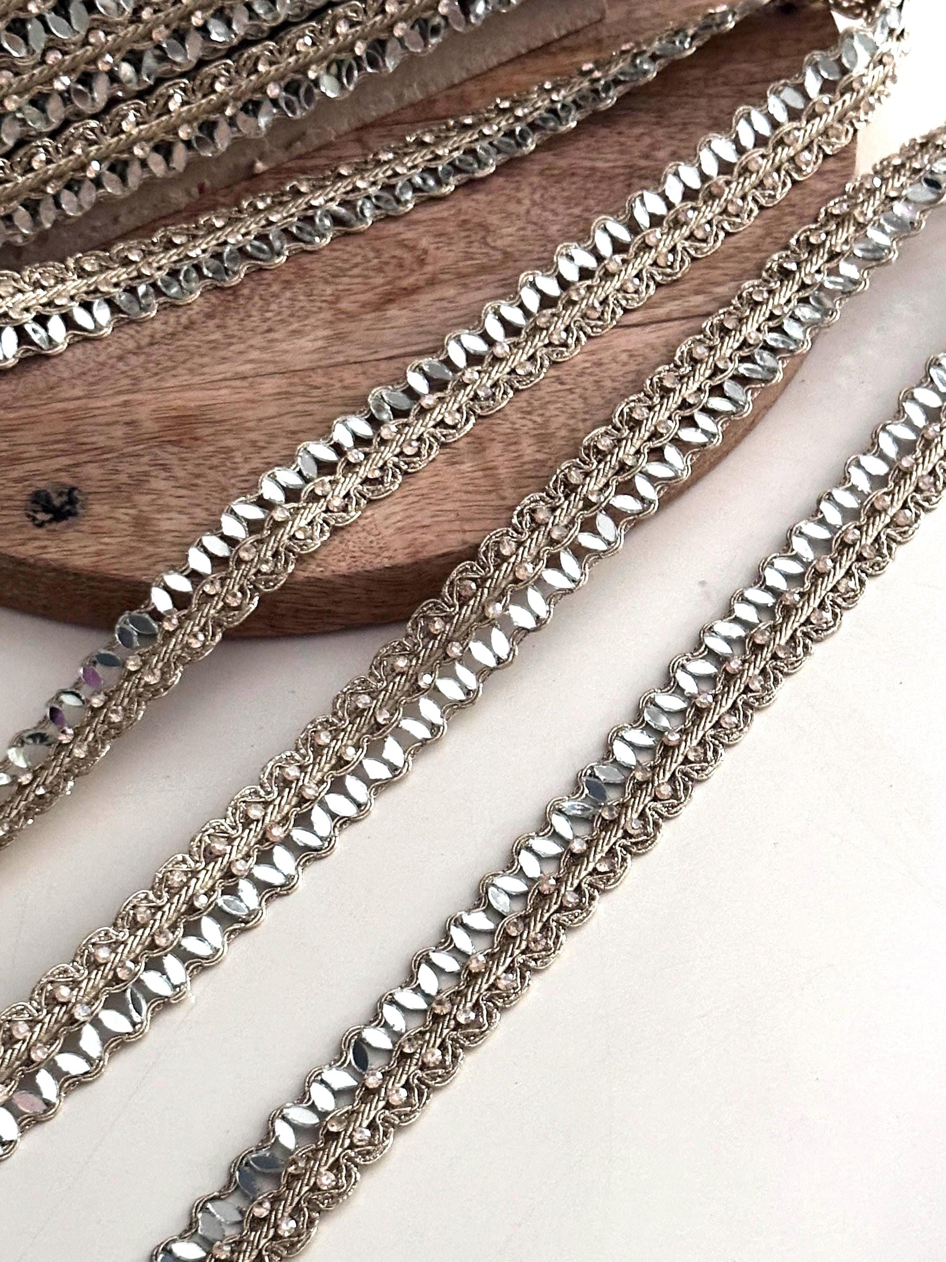 Golden crystal trim used as an elegant saree border, enhancing traditional Indian attire with a glamorous touch.