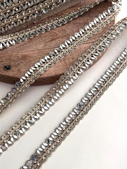 Golden crystal trim used as an elegant saree border, enhancing traditional Indian attire with a glamorous touch.